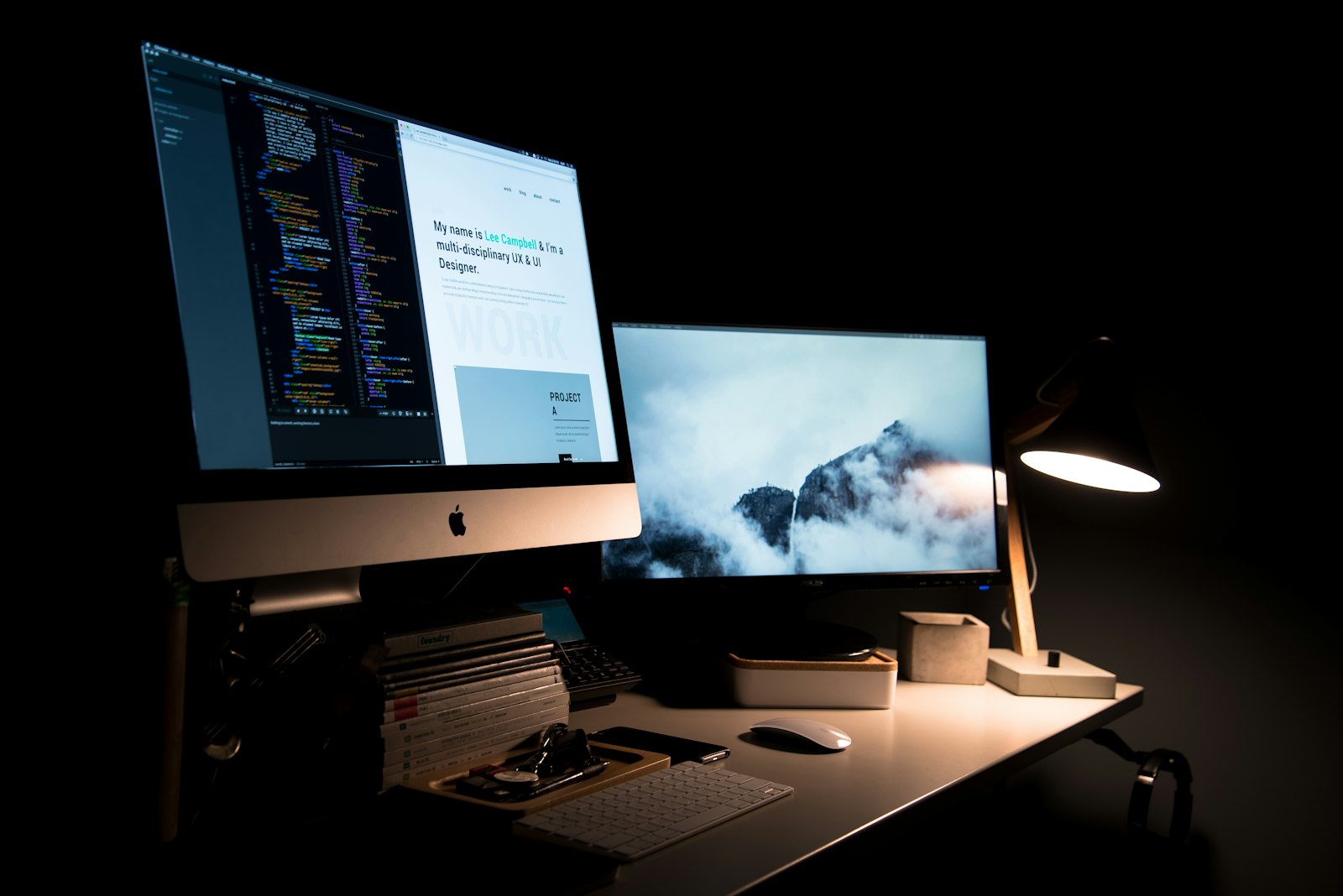 Website wireframes and interface layouts displayed on a large monitor