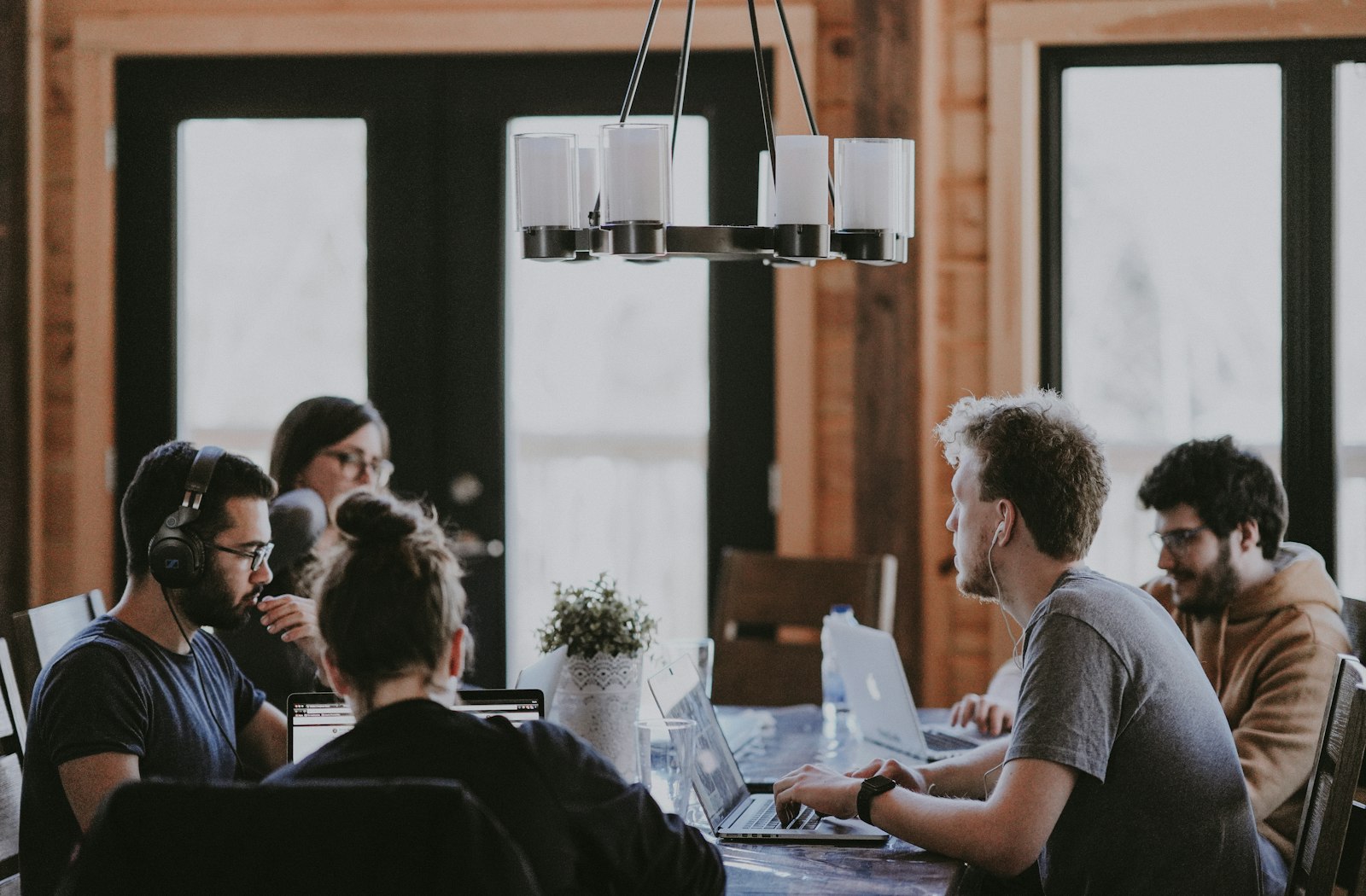Young technology professionals collaborating at a long office table